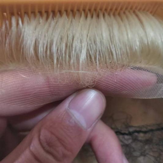 Extreme close-up of hand-tied hairline on ultra-fine French lace showing individual strands