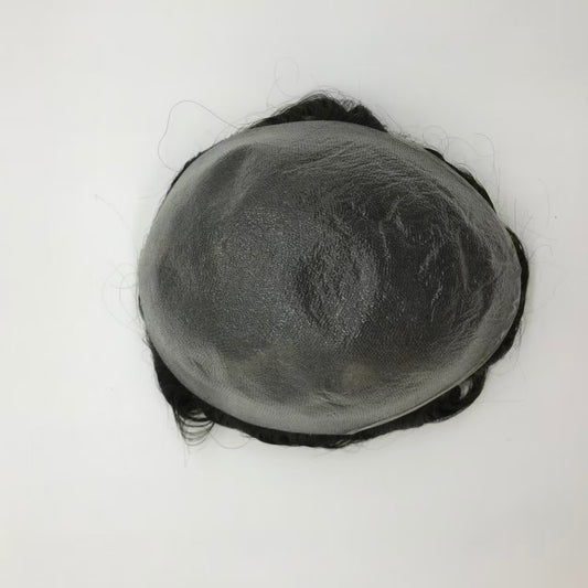 Top-back view of Ultra Thin poly skin base showing flat gray surface with curly hair