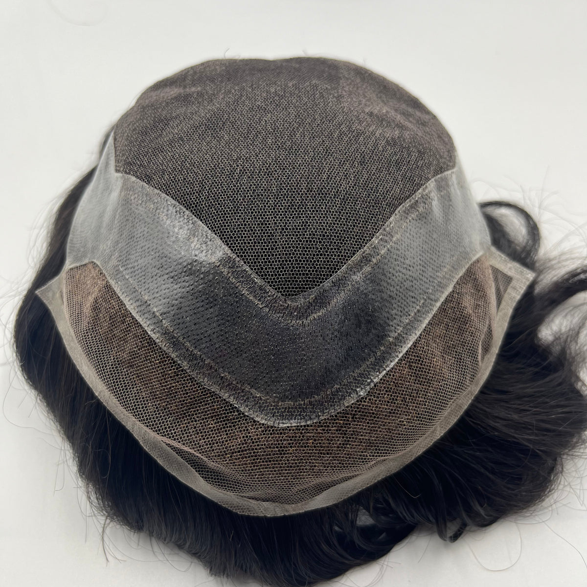 Back view of Hollywood system showing poly mesh base with ventilation and curly hair perimeter