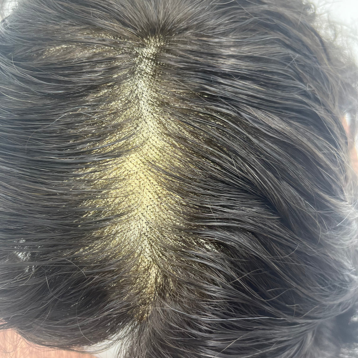 Macro view of hair part on French lace showing realistic scalp visibility and fine density