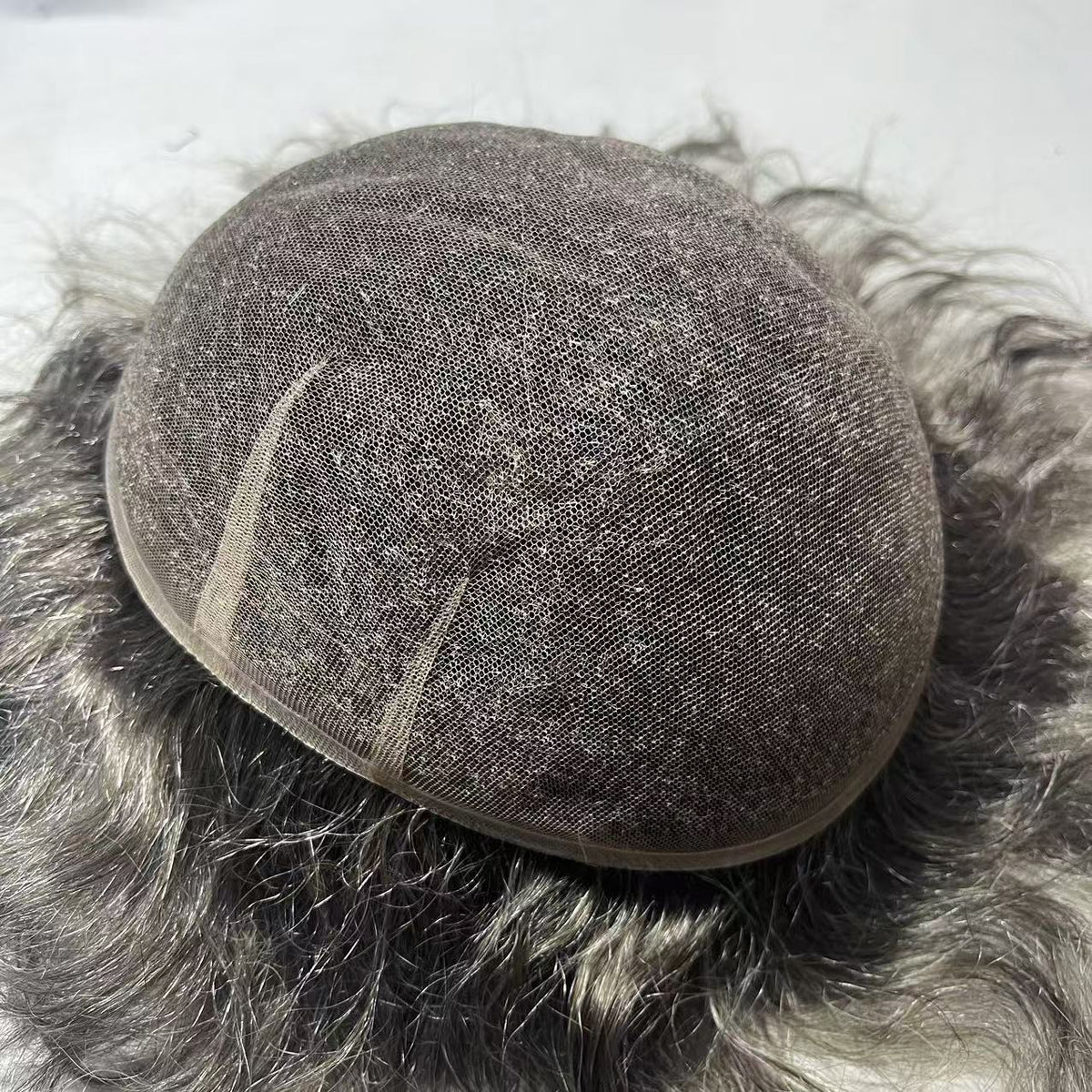 Top view of Full Swiss lace base in silver-gray showing uniform fine mesh and full hair